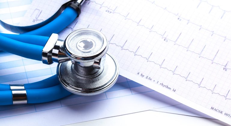 Stethoscope on cardiogram sheet